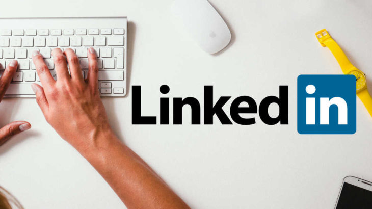 man typing and linked in logo
